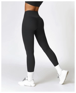 Close-up of high-waisted black yoga pants with push-up stitching and matte texture