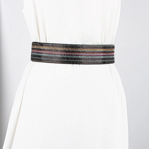Close-up of a wide elastic waist belt with colorful stripes of shimmering rhinestones