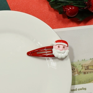 Close-up of a festive red hair clip featuring a cute 3D Santa Claus character decoration