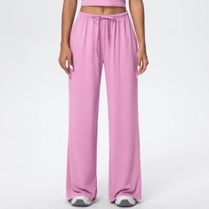 Detail of pink wide-leg lounge pants showing drawstring waist and soft draped fabric