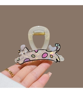 Detailed view of a cream claw clip with colorful polka dot cat pattern for thin hair