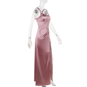 Detail view of rose pink satin dress featuring a high side slit and silky texture