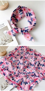 Detail of floral cotton linen neck scarf with soft pink and blue abstract patterns