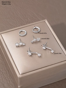 Detailed view of alloy earring set with cubic zirconia and dimension labels in packaging