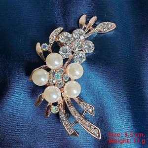 Detail of camellia brooch with cream pearls and rhinestones on rose gold base, 5.5cm size