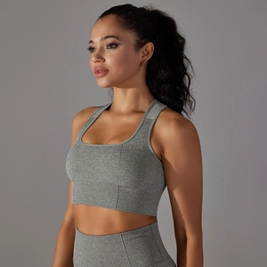Detail of seamless heather gray sports bra and leggings set with breathable knit texture