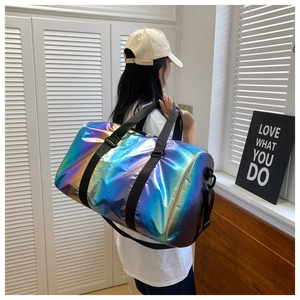 Detailed view of large gradient laser gym bag with adjustable strap worn by a model