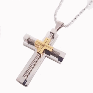 Detailed close-up of two-tone gold and silver cross necklace with twisted wire design
