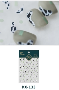Detail of KX-133 nail sticker featuring mint green and black cow print patterns