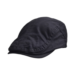 Detail of black cotton newsboy cap showing premium stitching and textured twill fabric