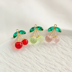 Three colorful resin cherry pendants in red green and pink with golden alloy frames