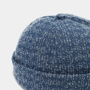 Close-up of retro washed denim docker hat showing heavy textured fiber details