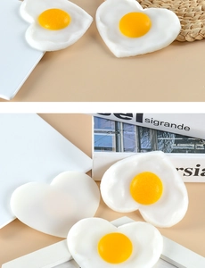 Detailed macro view of heart-shaped fried egg models made of high-quality PVC material
