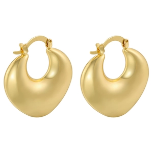 Macro detail of high-polish gold-plated chunky hoop earrings with snap closure