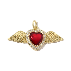 Detailed close-up of a heart-shaped pendant with red enamel and golden wings with zircons
