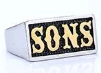 Macro view of square signet ring showing black embossed Sons text on a silver gothic band