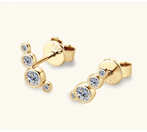 Macro shot of S925 sterling silver gold-plated pea stud earrings with moissanite stones