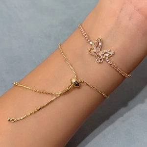 Macro shot of pink zircon butterfly bracelet featuring an adjustable gold chain