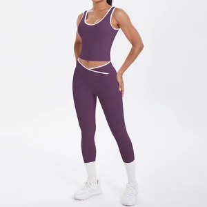 Detail of high-waist yoga pants with cross-waist design and white contrast piping