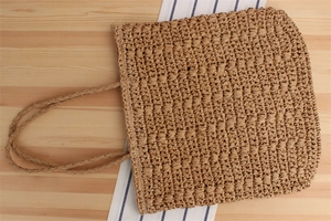 Close-up of the woven texture and handle of the summer paper rope tote bag