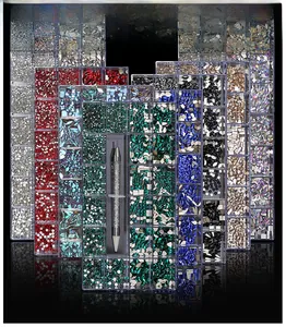 Macro shot of 21-grid nail art rhinestones kit with various colors and picking tool