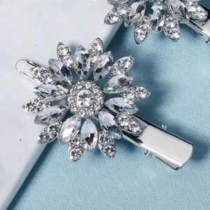 Elegant silver daisy hair clips with sparkling crystals in a stylish duckbill design