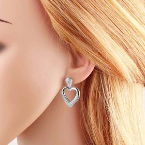 Silver-plated heart earrings with sparkling cubic zirconia on a model for a stylish look
