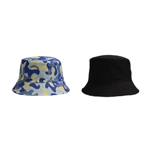 Detail view of camouflage and solid black canvas bucket hats with reinforced stitching