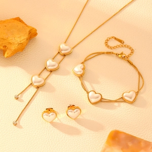 Elegant gold stainless steel jewelry set with heart pearls and sparkling tassels