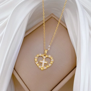 Luxurious gold heart cross necklace with sparkling diamonds and white shell inlay