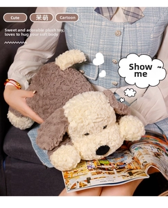 Close-up of soft grey and beige plush puppy toy with curly lamb wool texture