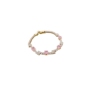 Elegant gold-tone tennis bracelet featuring pink square crystals and micro-set zircons