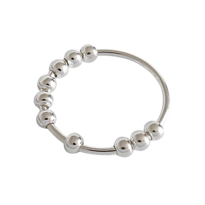 Close-up of rotatable silver beads on a minimalist anxiety relief spinner ring