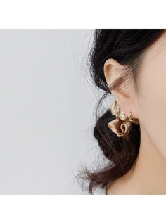Close-up of elegant gold geometric hoop earrings worn by a model for a minimalist look