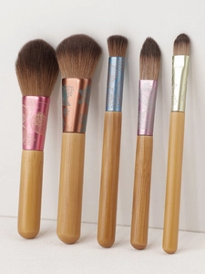 Detail of 5-piece mini wood handle makeup brushes with engraved colorful metal ferrules