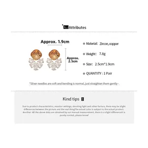 Detailed view of champagne zircon diamond drop earrings with silver needle specs