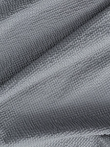 Detailed close-up of grey pineapple textured fabric with breathable honeycomb weave