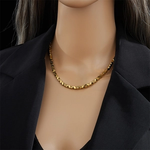 Geometric faceted bead necklace in gold-plated stainless steel on a female mannequin