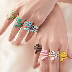 Multi-colored snake-shaped enamel rings with polka dots on a gold-plated open band