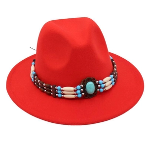 Close-up of red wool fedora with ethnic turquoise beads and wooden decorative band