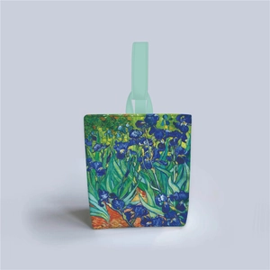 Detail of Van Gogh Irises print on canvas tote bag with green handle and artistic finish