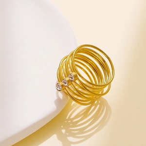 Detail of 18k gold plated multi-layer coil ring with three sparkling inlaid zircons