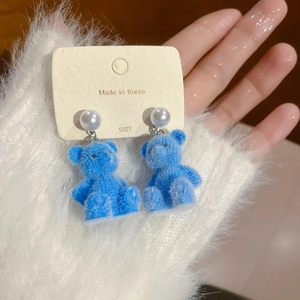 Detailed view of blue flocked bear earrings with S925 silver needles and white pearls