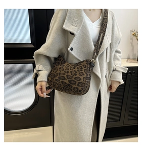 Detail showing vintage leopard print crossbody bag with matching printed shoulder strap