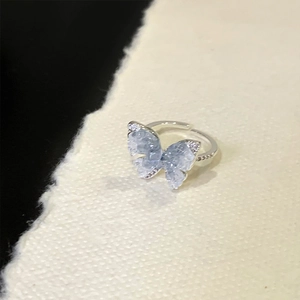 Detail of adjustable silver ring with a translucent gradient blue butterfly crystal