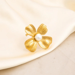 18K gold plated stainless steel clover ring with pearl on soft beige silk background