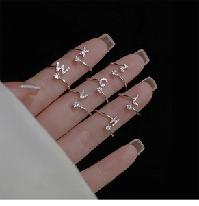 Detailed view of S925 sterling silver initial rings featuring sparkling micro-pave crystals