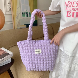 Detailed shot of lavender popcorn texture tote bag with branded square fabric label