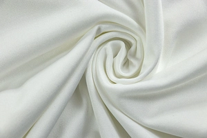 Macro shot of white knitted fabric texture showing fine weave and soft elastic material