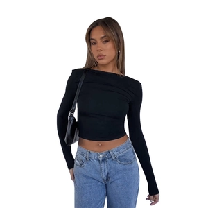 Slim fit black long sleeve crop top paired with blue jeans for a modern casual autumn look